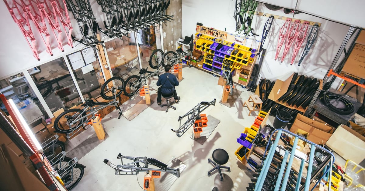 Bicycle frames and parts arranged in a workshop