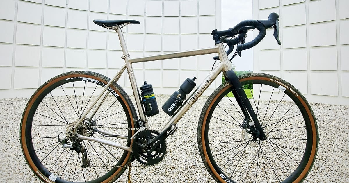 A road bike photographed side-on against a plain backdrop